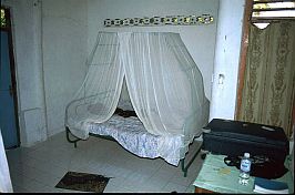 Bett mit Moskitonetz in meinem Zimmer in Seba