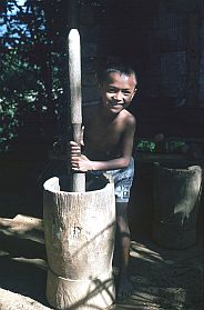 Junge am Reisstampfer